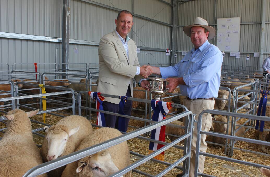 Member for Upper Hunter Michael Johnsen presents the HD Fairfax Challenge Cup to successful local Prime Sheep exhibitor, Ray Inder