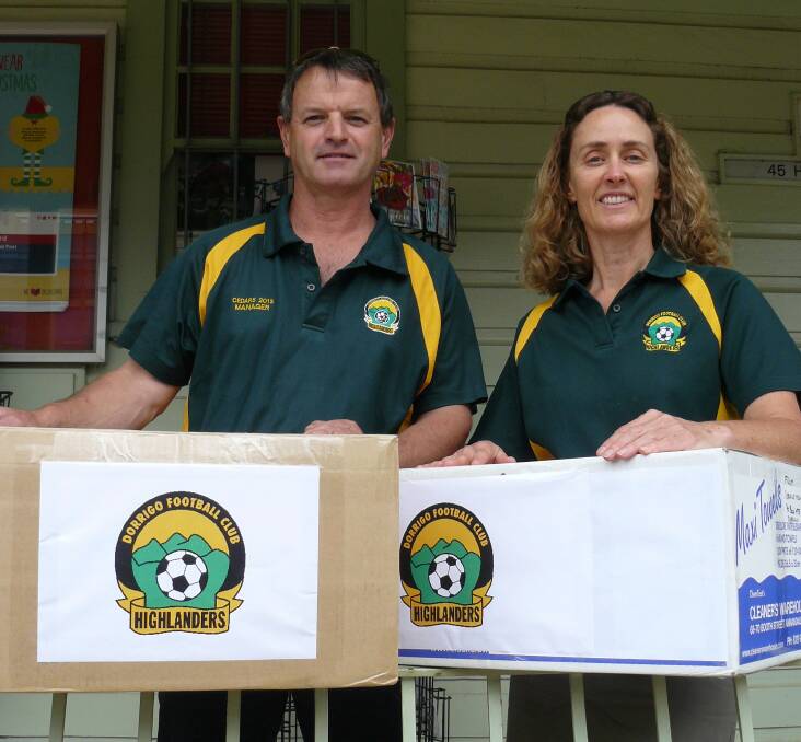 Club President Peter Smith and Treasurer Barbara Webster send two boxes of upcycled football shirts to Kit Aid from Dorrigo Post Office.