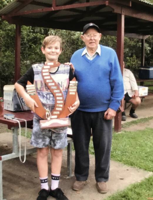 Eel Fishing Champion Eli Williams with the Waterhole Wal Perpetual Trophy presented by organiser Wal Tyson