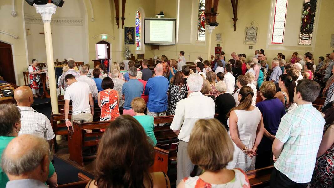 Members of the congregation sing a carol during the Christmas morning service at Mt David's church in Albury.