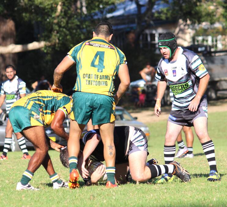Peter Glyde in his 3rd game for the day being tackled with Luke Rose ever ready to distribute the ball.
