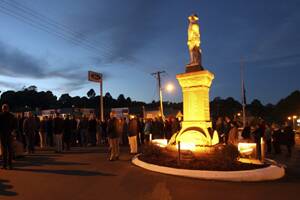 A crowd of nearly 300 faces east towards the rising sun during the Anzac Dawn Service at The Monument, Dorrigo