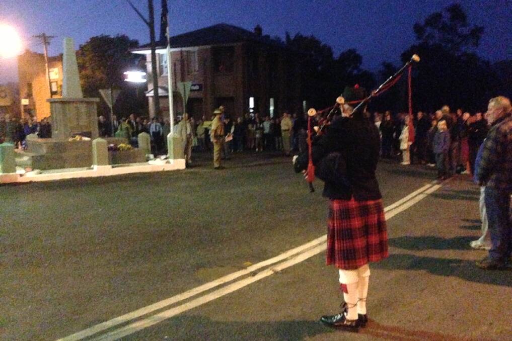 Pipe Major Rod McGrath of the Bellinger River District Pipe Band plays The Lament at the Dawn Service in the mid-north coast town attended by 300 people. Pic: Mark Dodd)
