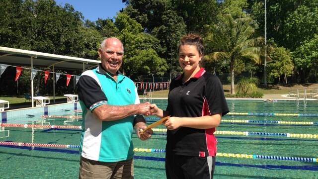 President Rob Anderson presenting the cheque to Hannah Taylor from the 19 years team.
