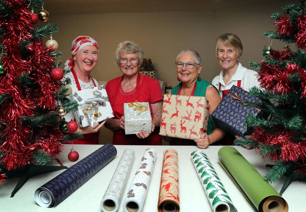 PERFECTLY WRAPPED: Linda Mee, Dawn Woodland, Karen Alcorn and Sue Stoll all volunteer their time to wrap gifts. Picture: Les Smith 