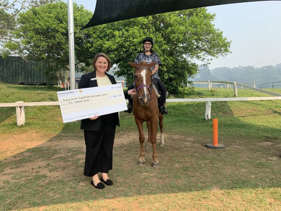 Kate Bear from Bellingen CommBank presenting the cheque with Nikala at Riding for the Disabled