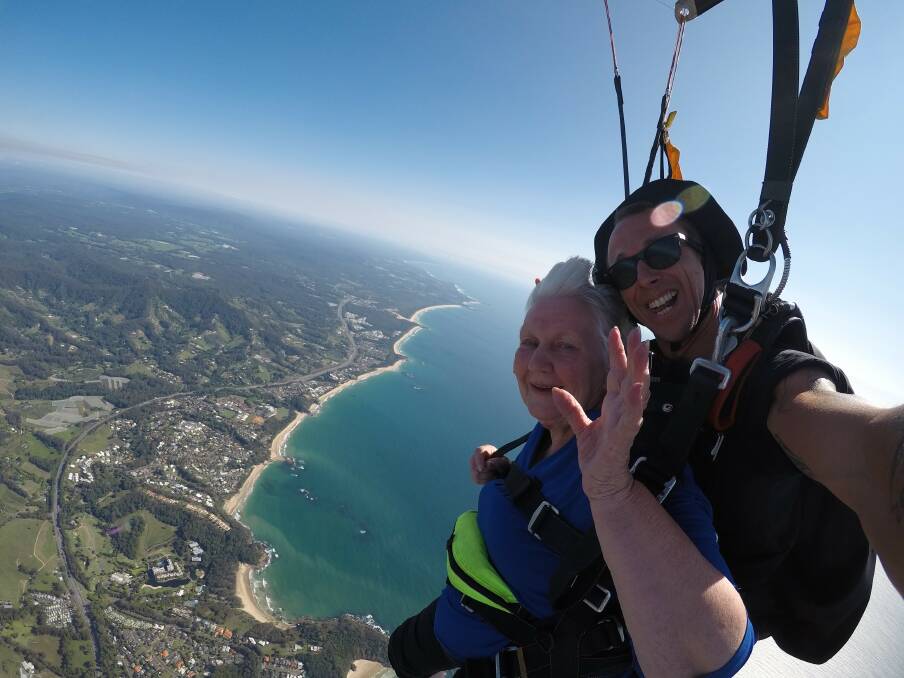 Urunga's Jan Hogan and instructor Wiley Cochrane suspended over the coastline
