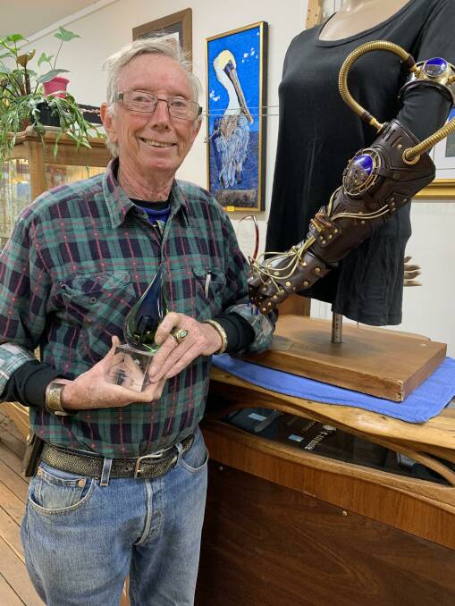 Mac and the prizewinning steampunk arm in his Hyde St shop