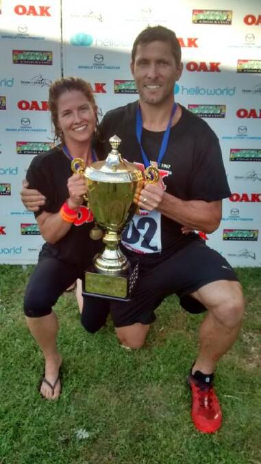 Amanda and Adrian with their trophy from the wife-carrying Australian championship