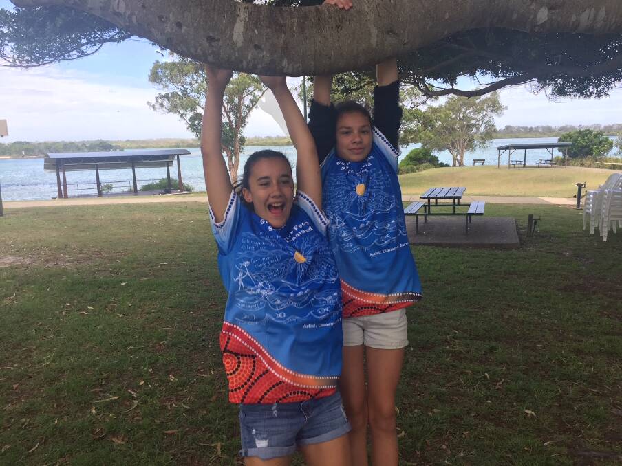 Shardonnae White and Makeisha Donnelly wearing the commemorative T-shirts of the Gumbaynggirr native title determination.