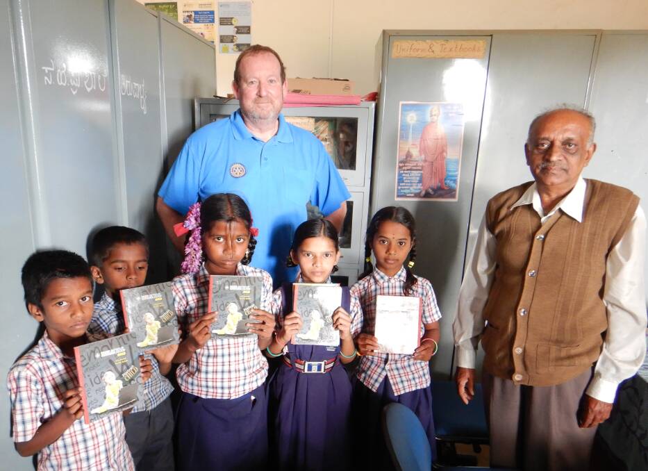 David Scott presenting workbooks to the pupils of Thirupalya Primary School (Bangalore, India).