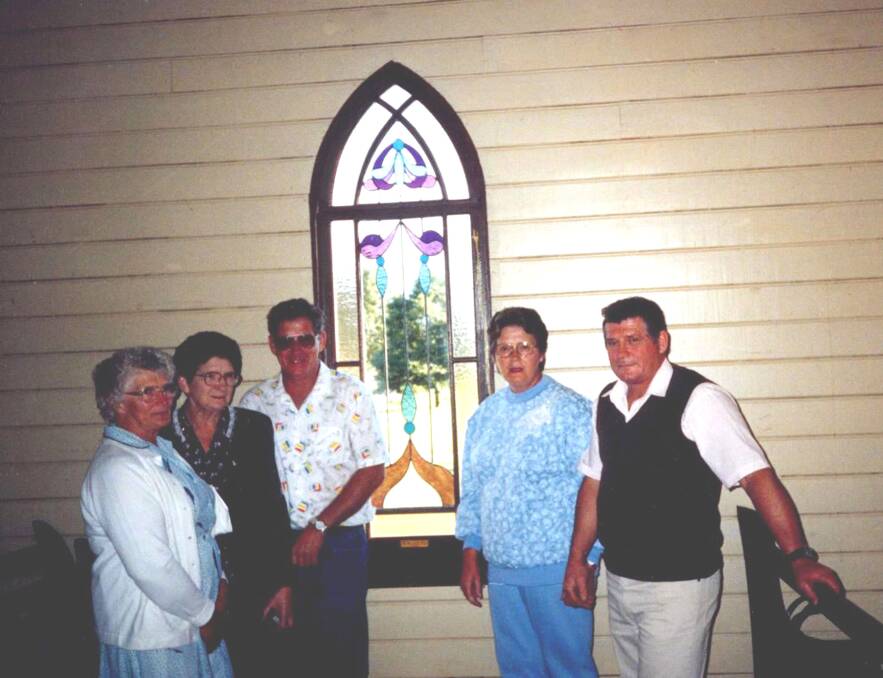 Gabe and Hilda's children standing in front of the donated window in the church at Gleniffer - Eva, Norma, Garry, Dawn and Roy