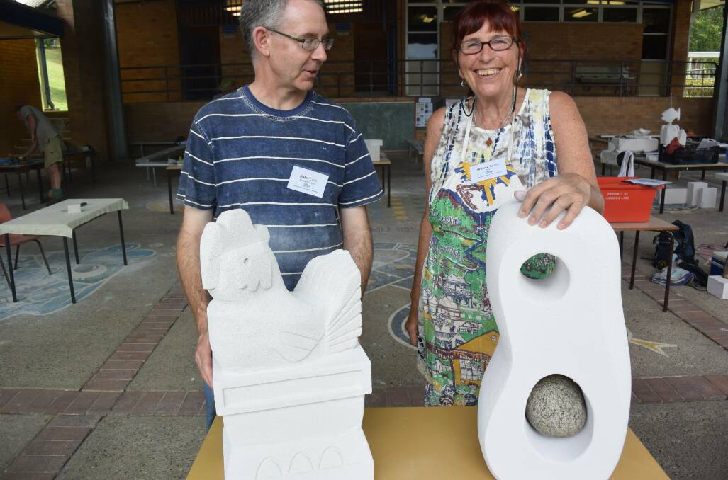 Peter Cook from Maitland with his chicken, and Wendy Tanner from Thora, whose carved pregnant female form was a gift for her son and pregnant daughter-in-law