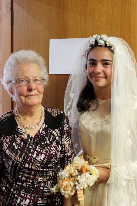 Nancy Taylor and Tayla Bain. Tayla wore Nancy's wedding dress from 1953 at the 10th anniversary celebration of Stitched Up, a mentoring group that teaches girls how to sew. Photo Anna Young