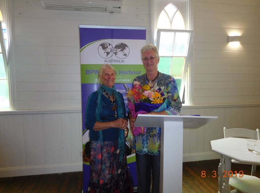 Anne Hickey presenting flowers to Andrea Cross