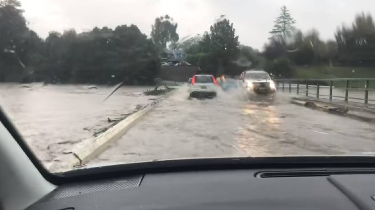 Cars rushing over Lavenders Bridge Bellingen before it closed this morning