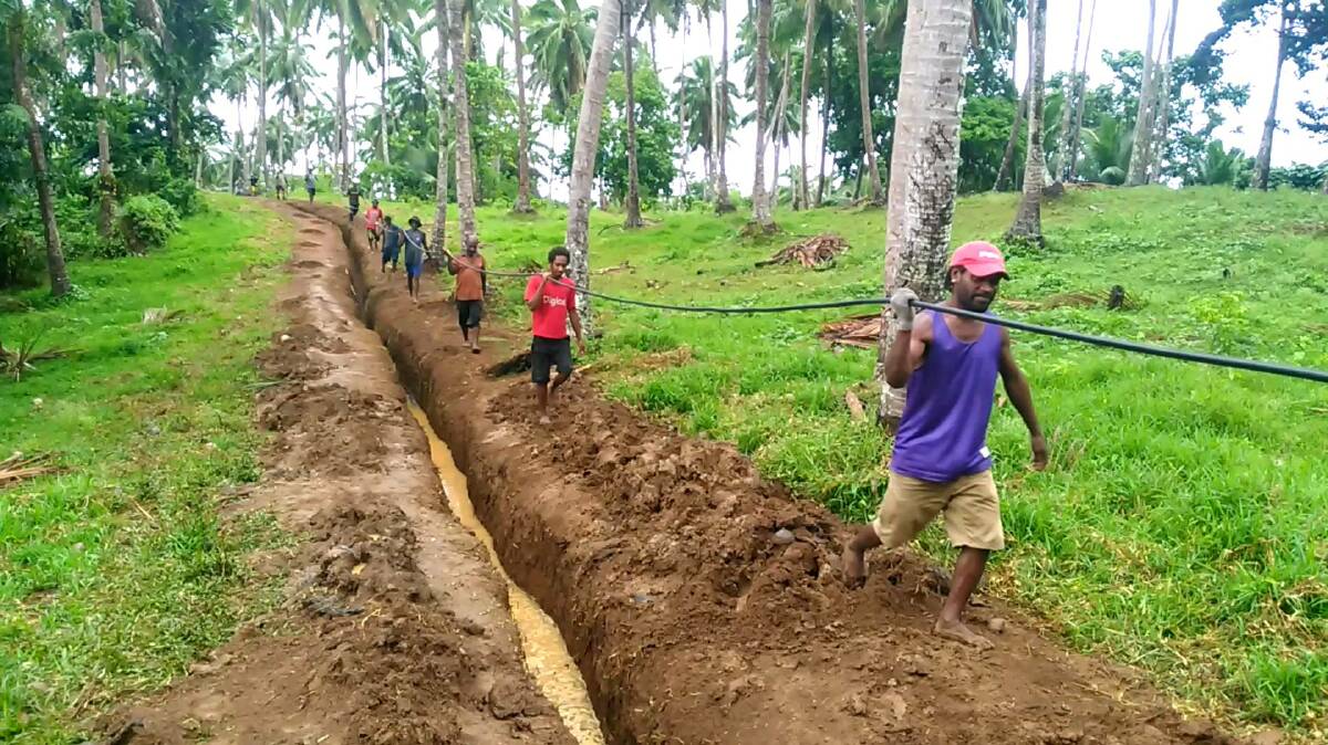 Locals carrying high voltage cable in 2018