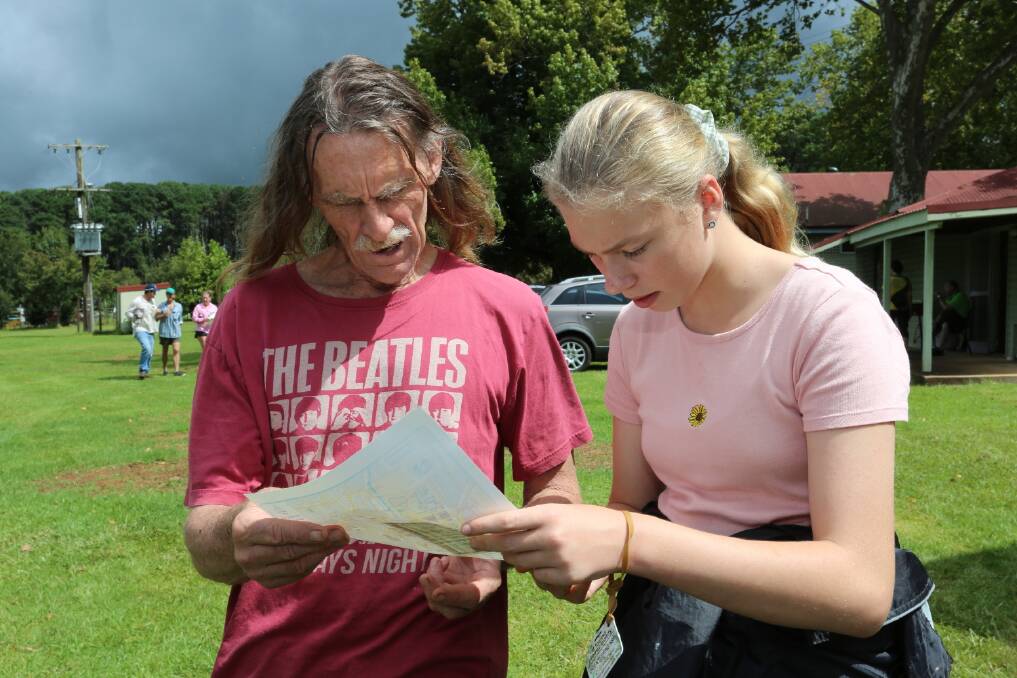 Simon Clarkson helps Holly Shaw of Dorrigo check her map before starting the event