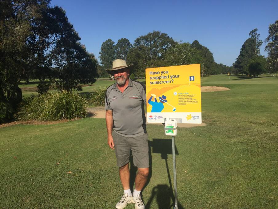 Nick Jenkins, Bellingen Golf Club director, sporting a hat and standing with the sunscreen dispenser.
