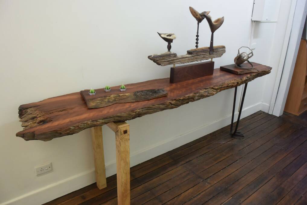 A rosewood side table made by Bruce Jacups with a sculpture by Adrienne Hmelnitski on top