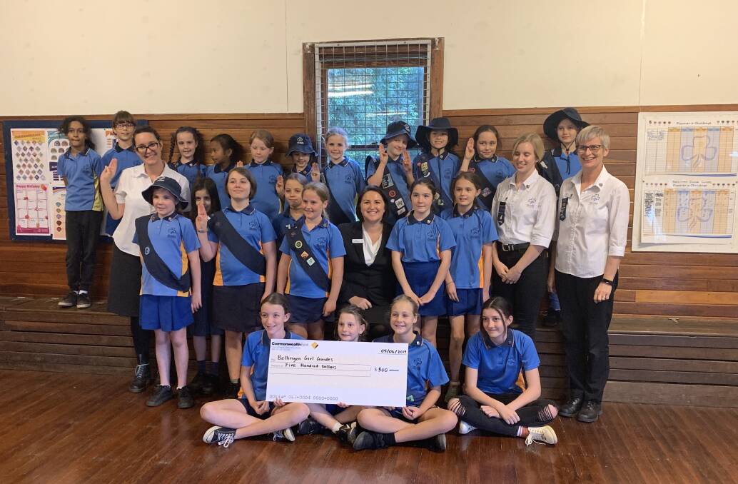 CBA employees and members of the Girl Guides at the cheque presentation