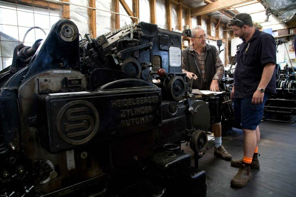 Compositors Alan Smith and Jason Wilson with the Dorrigo printing press in 2010. Photo Roy Hunt