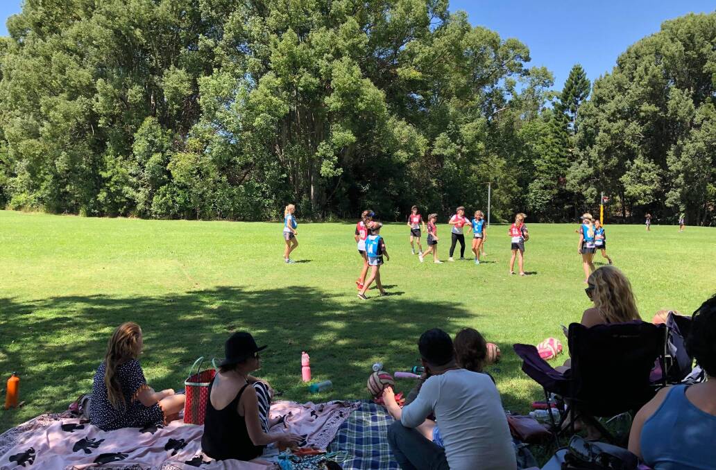 Families happily watching our Bellingen netballers in their first game of 2019