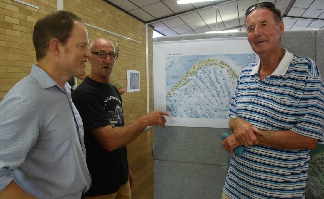 GHD's Shaun Lawer discusses the latest draft plan with Urunga locals Ken Sharkey, who said it was "pretty good" and Bruce Pettit.