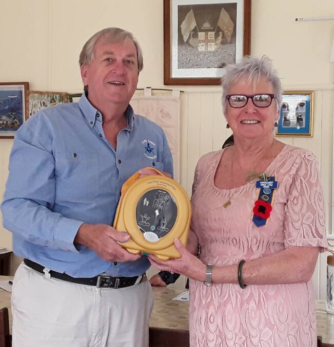 President of the Coffs Coast Freemasons Association Phil Robertson presents Urunga CWA President Margaret Grice-Little with a new defibrillator for the CWA rooms. Photo by Alison Carter.