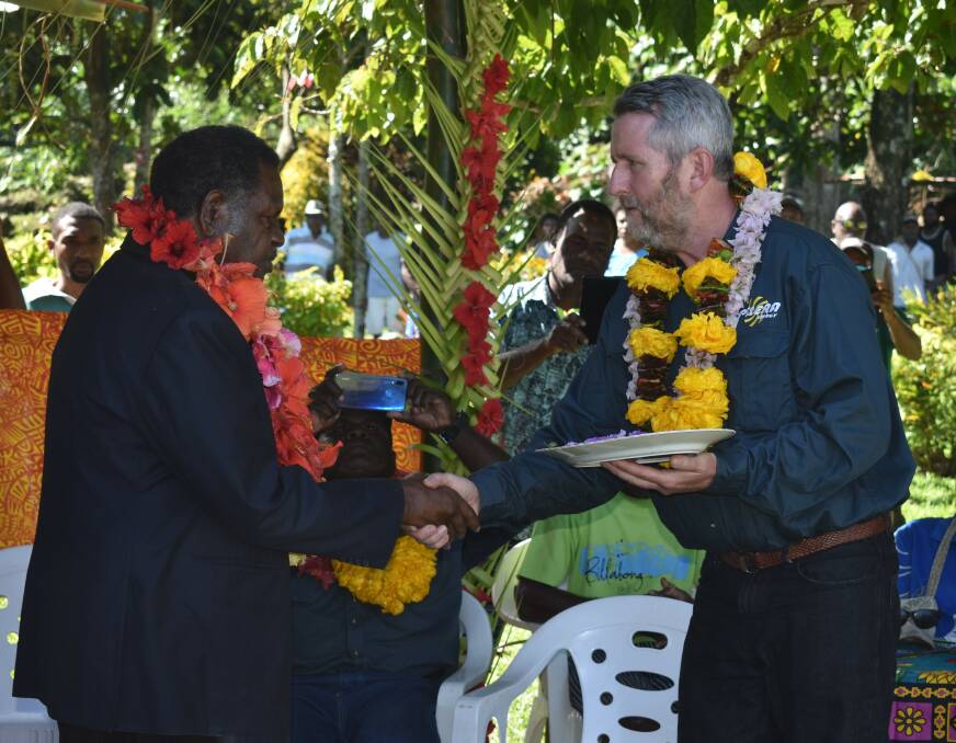 Peter Lynch (right) officially handing the keys for Talise Hydro Stage 2 to Vanuatu's Minister of Planning and Climate Change Adaptation, Ham Lini Vanuaroroa
