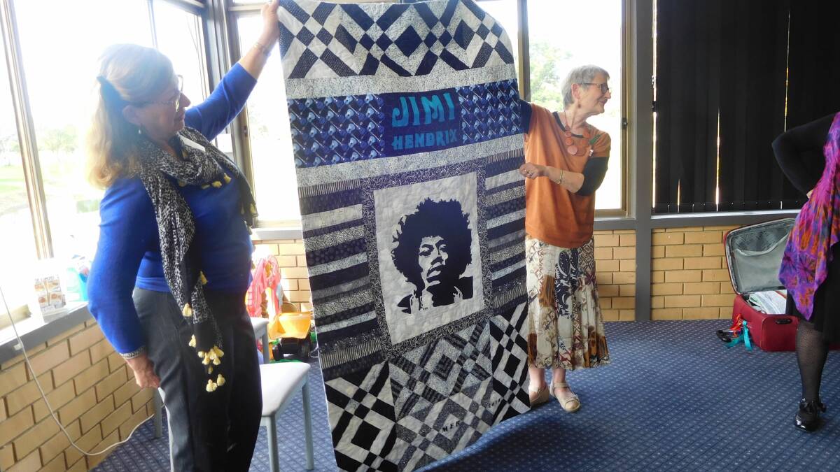 Kaye Clarke and Lyn Proctor hold up Aussie Quilt.