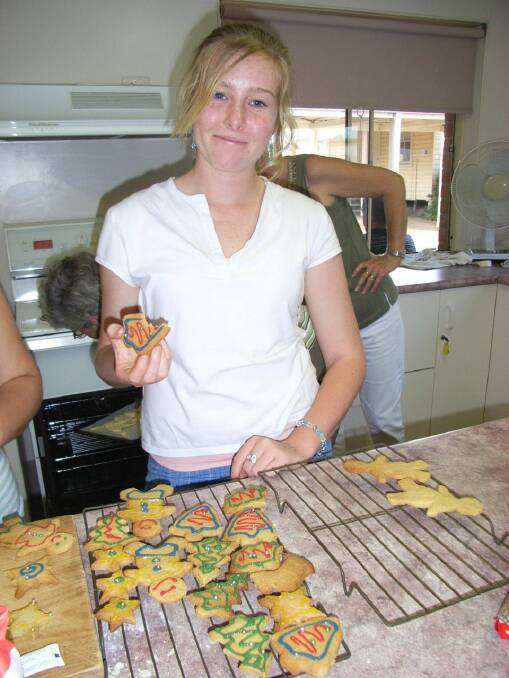 Erin Locke testing the gingerbread men for the first Stitched Up Christmas high tea in 2008 .