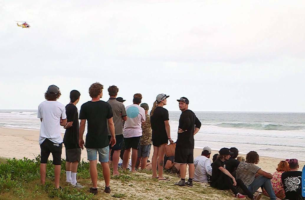  Concerned locals watch the Valla Beach search. On Saturday February 17 a 22-year-old man became stuck in a rip and was reportedly swept out to sea. Photo: Frank Redward

