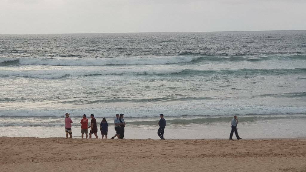 Concerned locals watch the Valla Beach search.