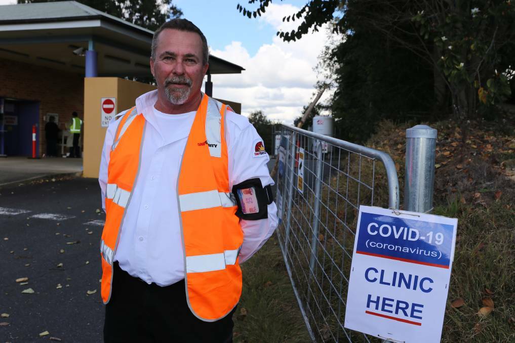  Security guard Derek Alsleben greets people at the entrance to Macksville's drive-through COVID clinic, which is open Monday to Friday, 9am to 1pm