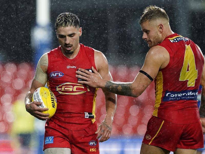 Izak Rankine, left, almost won the match for Gold Coast in Wednesday's draw with Essendon.