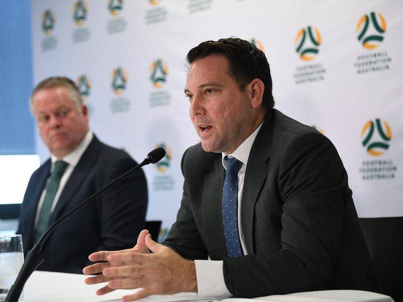 FFA chief James Johnson (R) says a decision on the A-League will hinge on the "latest directives".