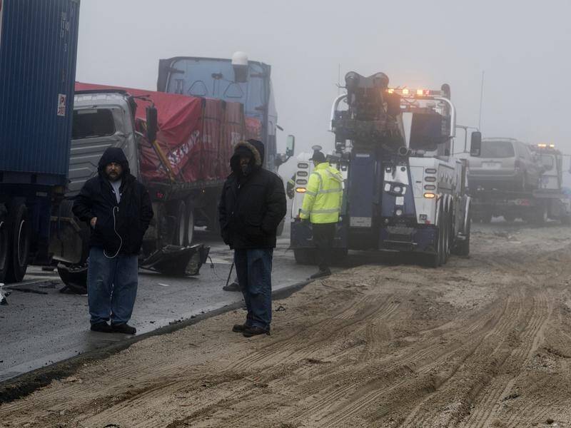 Truck drivers among damaged semitrailers at the scene of a multi-vehicle collision in California.